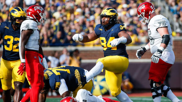 Michigan defensive lineman Kris Jenkins (94) celebrates a sack against UNLV quarterback Doug Brumfield (2) during the first half at Michigan Stadium in Ann Arbor on Saturday, Sept. 9, 2023.